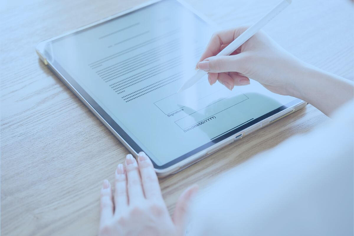 Marketer signing influencer contract on tablet Marketer signing influencer contract on tablet